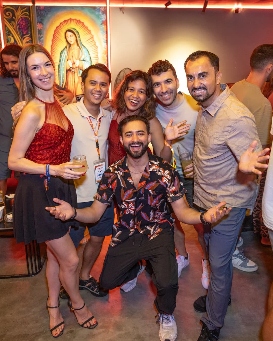 A group celebrating by the mural wall